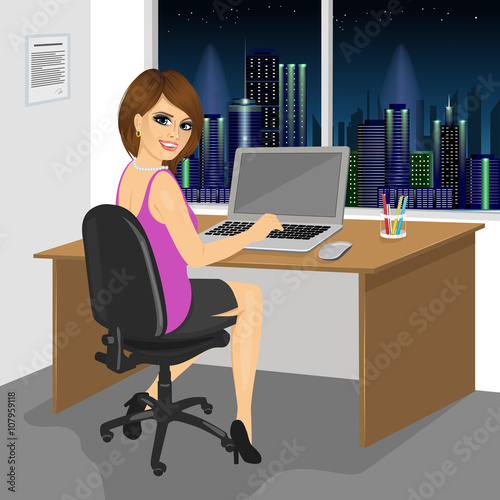 back view of successful businesswoman sitting working with laptop at office