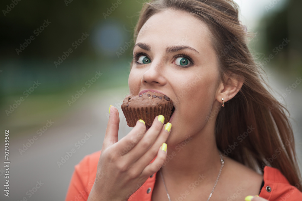 Cupcakes woman eating cupcake in, Central Park. Business woman eating