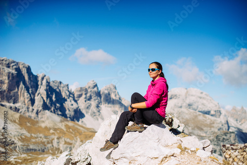 Young sports girl admiring views of the mountains in the Alps