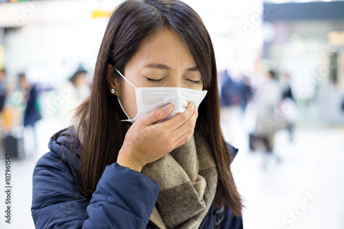 Woman wearing face mask at train station