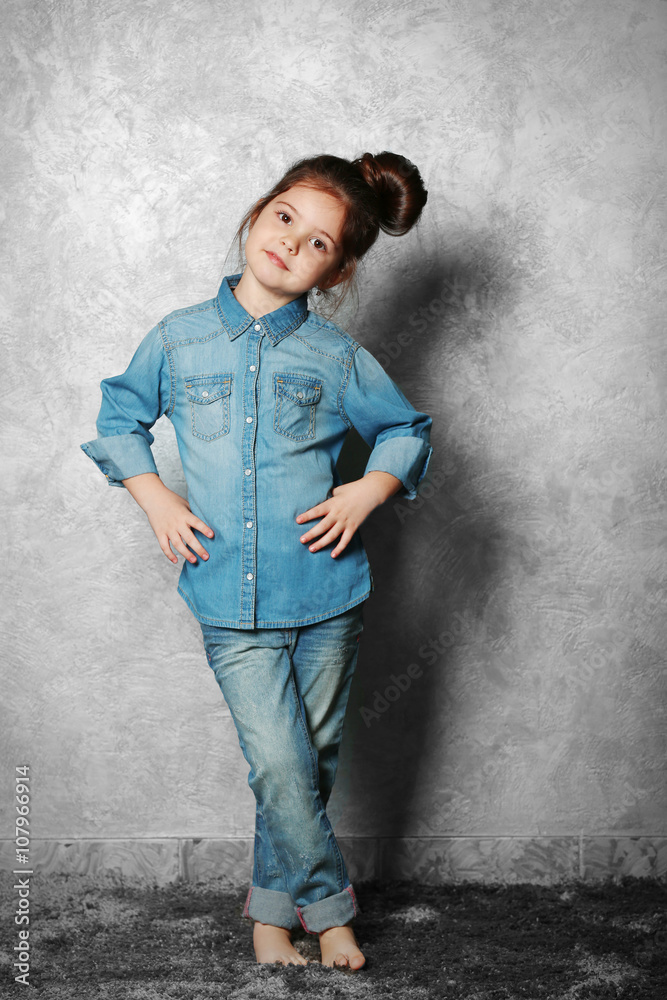 Portrait of little fashion kid girl on gray wall background Portrait of little fashion kid girl on gray wall background
