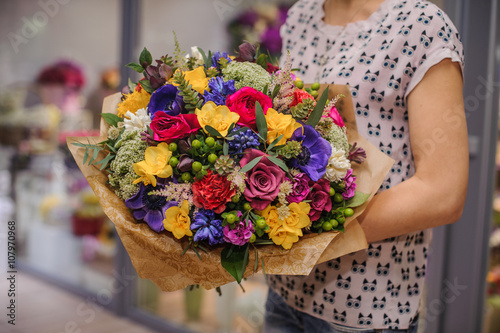 colorful bouquet with different flowers in hands