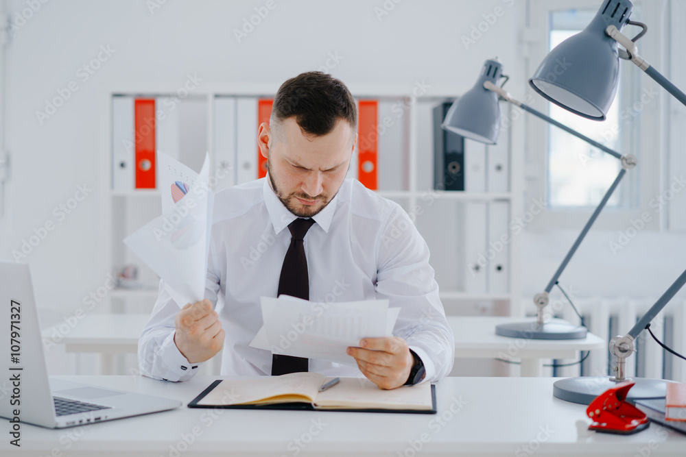 confused businessman examines documents confused businessman examines documents