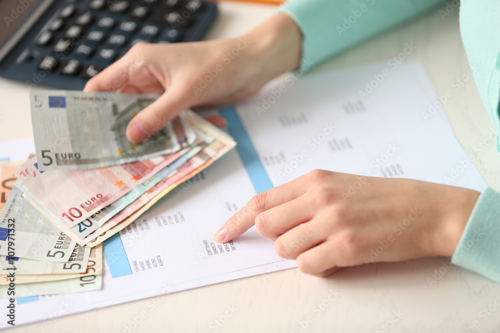 Woman counting money at the table Woman counting money at the table
