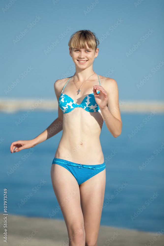 floor vertex Towing Attractive slim teenager girl in bikini runs along the beach Stock Photo |  Adobe Stock