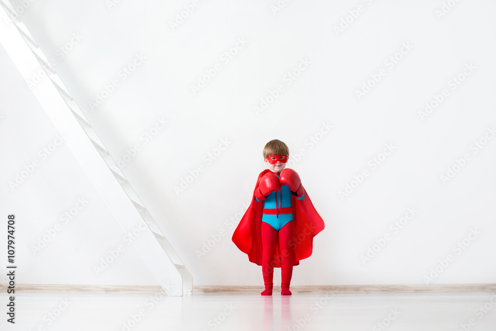 Child with boxing gloves and a red cloak.