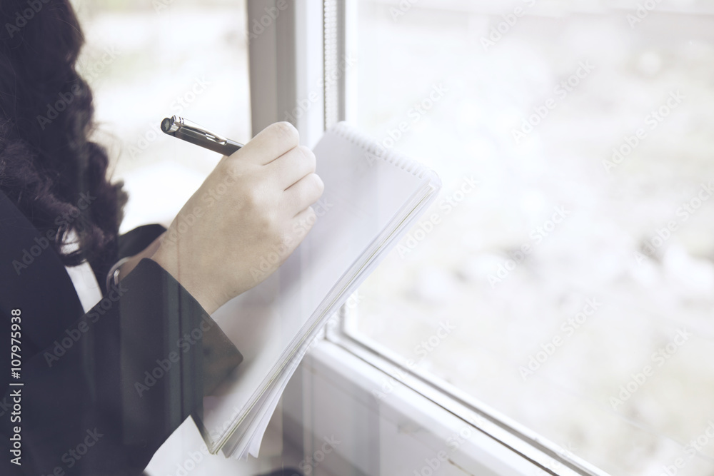 Business woman taking notes.