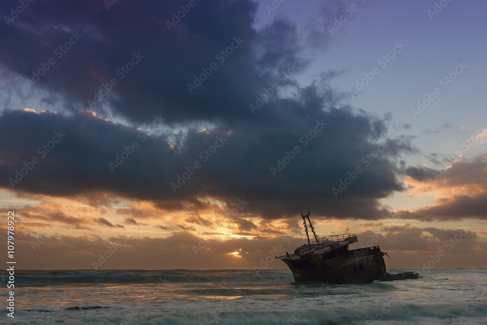Old shipwreck long exposure on the rocks sunset Old shipwreck long exposure on the rocks sunset