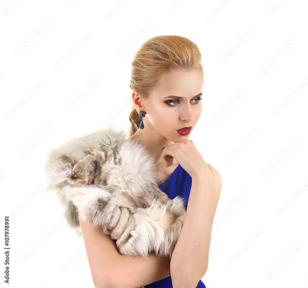 Young beautiful blonde girl wearing perfect makeup and dress in a fur over white studio background Young beautiful blonde girl wearing perfect makeup and dress in a fur over white studio background