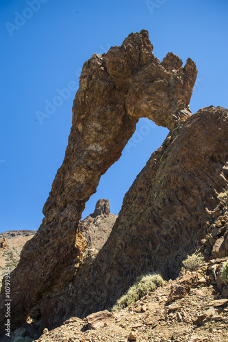 Natural volcano stone arch .