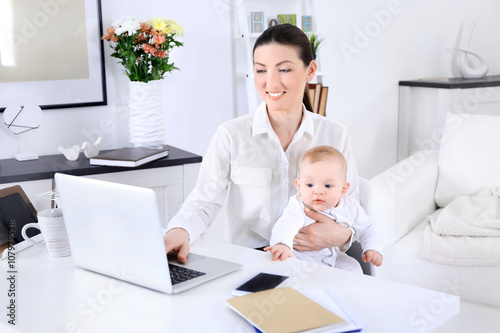Businesswoman with baby boy...
