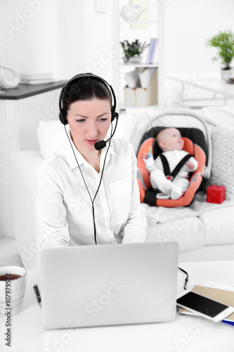 Businesswoman with baby boy...
