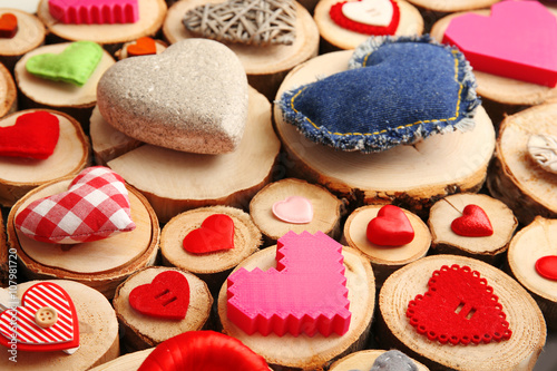 Set of different craft hearts on wooden logs