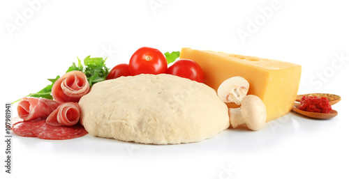Fresh dough and other different ingredients for pizza isolated on white