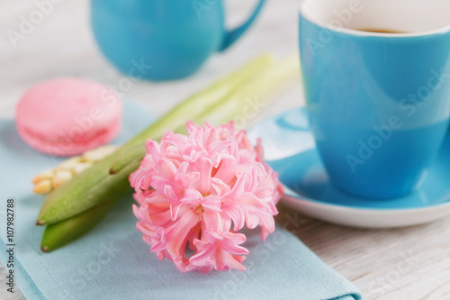 Cup of black coffee and pink flower