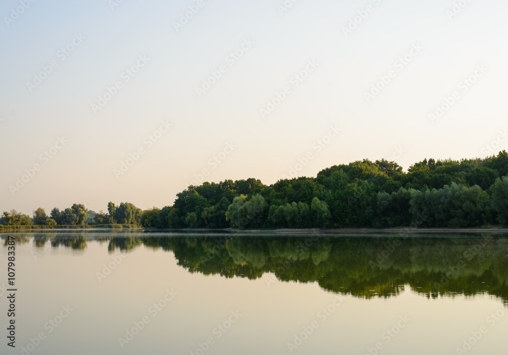 Tranquil lake with reflections at dawn or dusk