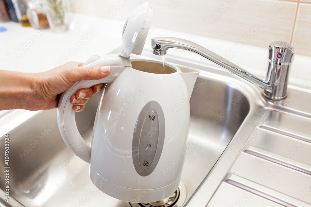 Pouring water into an electric kettle