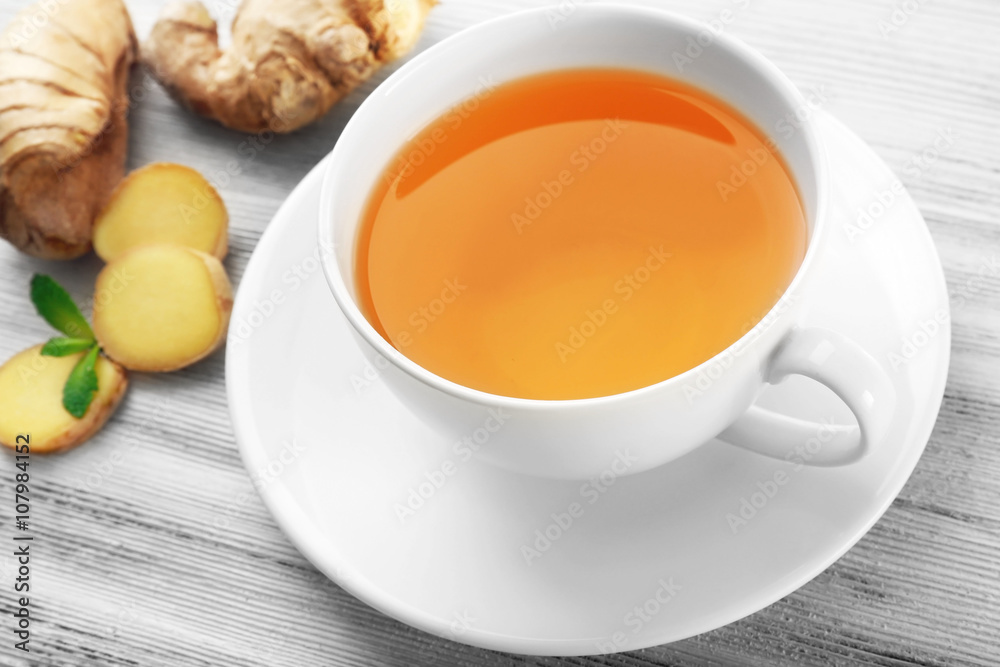 Cup of tea with ginger on a light wooden background Cup of tea with ginger on a light wooden background