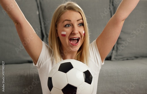 Polish fan cheers football team in the national colors.