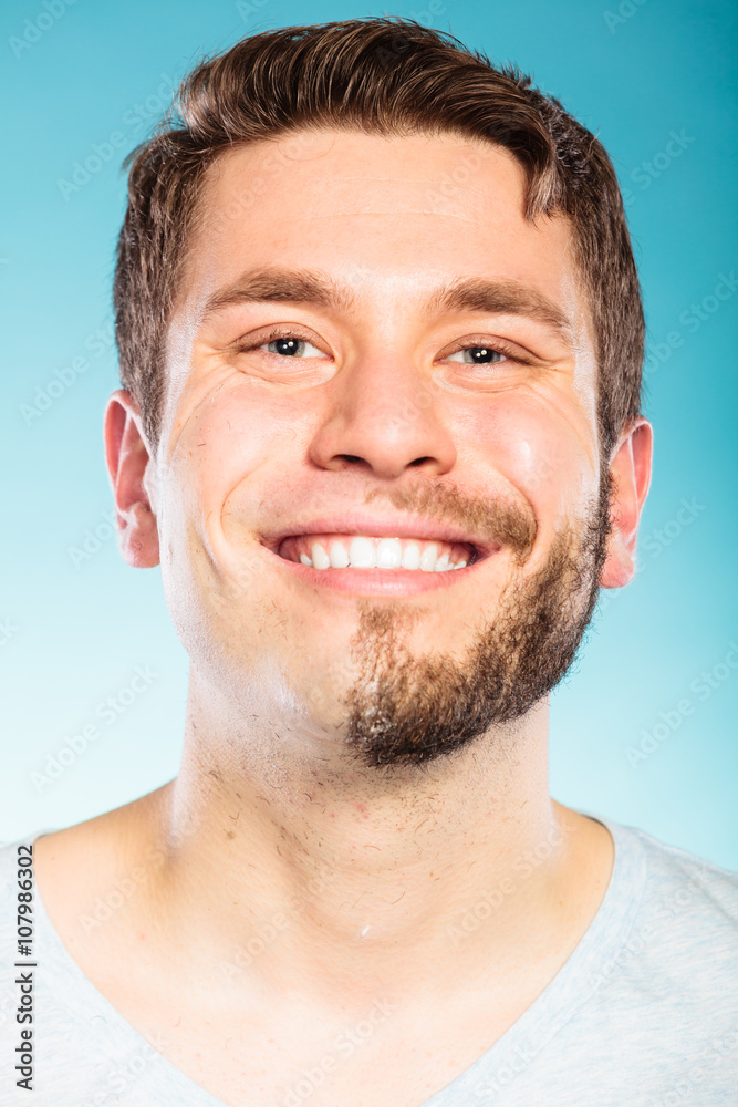 Fototapeta premium Happy man with half shaved face beard hair.