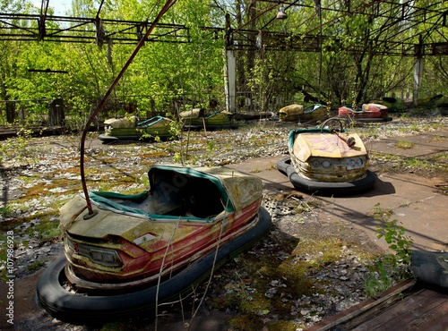 Bumper cars in abandoned amusement park in Pripyat town in Chernobyl Exclusion Zone, place of Chernobyl nuclear disaster in Ukraine at spring © Olena Ilienko