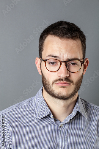 feeling depressed and disappointed young man with beard and eyeglasses © STUDIO GRAND WEB