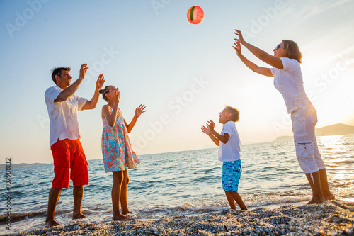 Fotografie Family play on beach