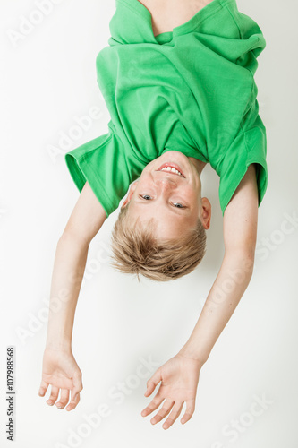 Upside down boy in green shirt
