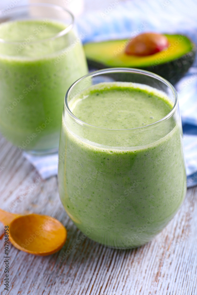 Avocado smoothie on wooden table closeup Avocado smoothie on wooden table closeup