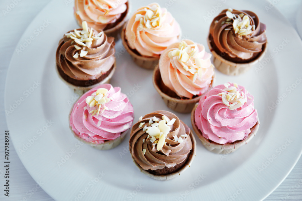 Creamy cupcakes on table closeup Creamy cupcakes on table closeup