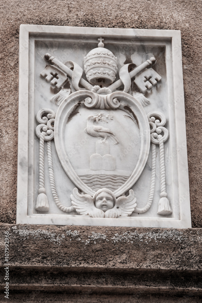 Marble coat of arms on the wall of a building