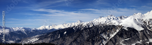 Panoramic view on snowy mountains in sun windy day © BSANI