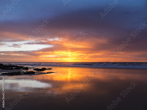 Sunset at the beach with intense glowing orange, yellow, red col © sotavento1000