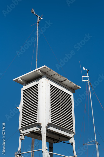 A Stevenson screen or instrument shelter is an enclosure to shield meteorological instruments.  It forms part of a standard weather station. photo