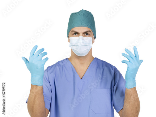 close-up image of a nurse wearing surgical mask, cap and gloves.