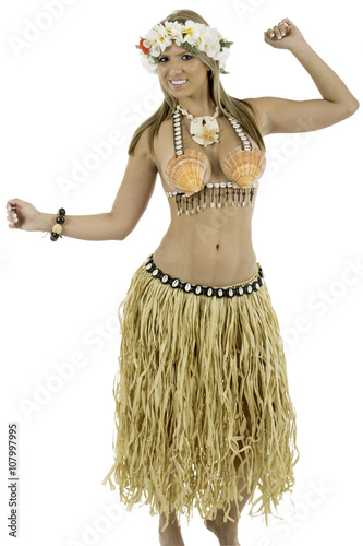 Pretty woman dressed in Hawaiian costume made of sea shells and wearing a lei. looking at camera smiling shot on white background.