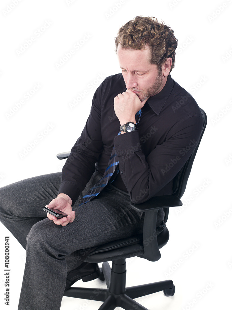 young doctor reading text message with hand on chin. young doctor reading text message with hand on chin.