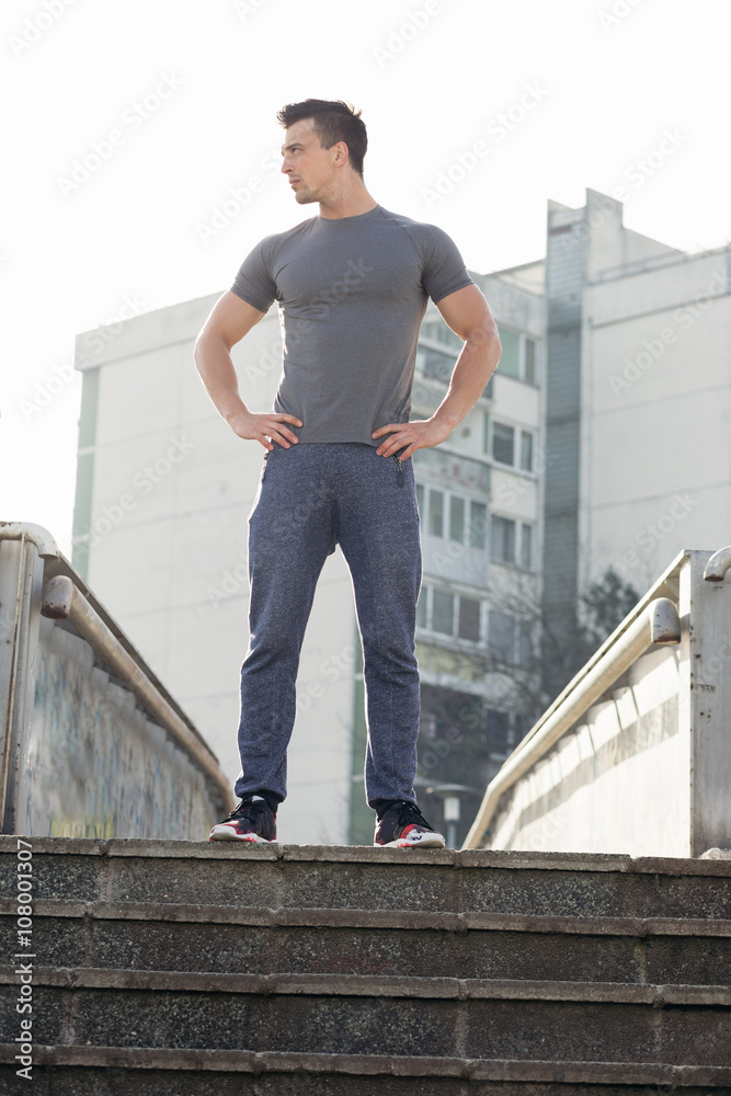 Portrait of a strong fit men dressed in sportswear jogging on th Portrait of a strong fit men dressed in sportswear jogging on th