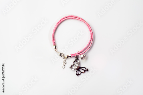 Close-up of handmade bracelet made with pink leather, crystal gl