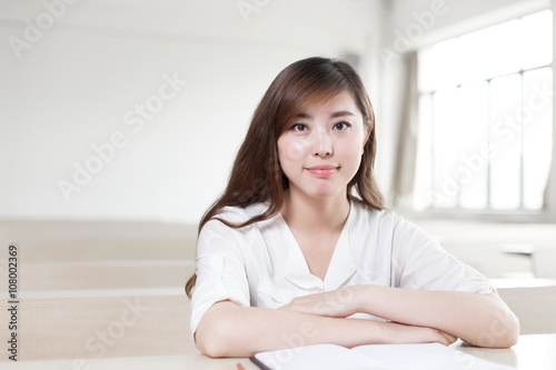 asian girl student with book in modern library Free Download asian girl student with book in modern library - GFXLoad