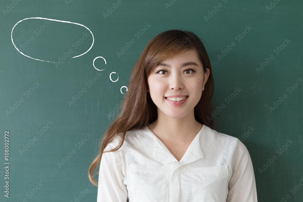 beautiful girl teacher with green blackboard