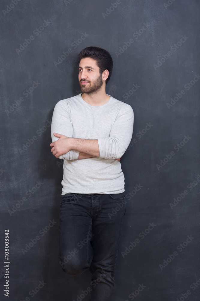 Handsome and confident. Handsome young man smiling while standi Handsome and confident. Handsome young man smiling while standi