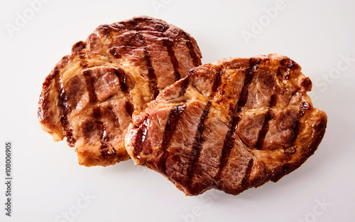 Two grilled marinated beef neck steaks