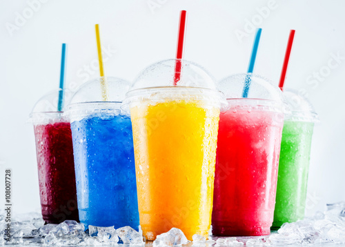 Colorful Frozen Fruit Slush Drinks in Plastic Cups photo