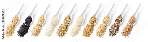 Assortment of cereals. From left: oats, black rice, brown rice, carnaroli rice, buckwheat, basmati rice, khorasan wheat, barley, quinoa, spelt. White background, top view, flat lay. photo