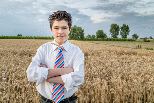Handsome boy in a golden wheat field
