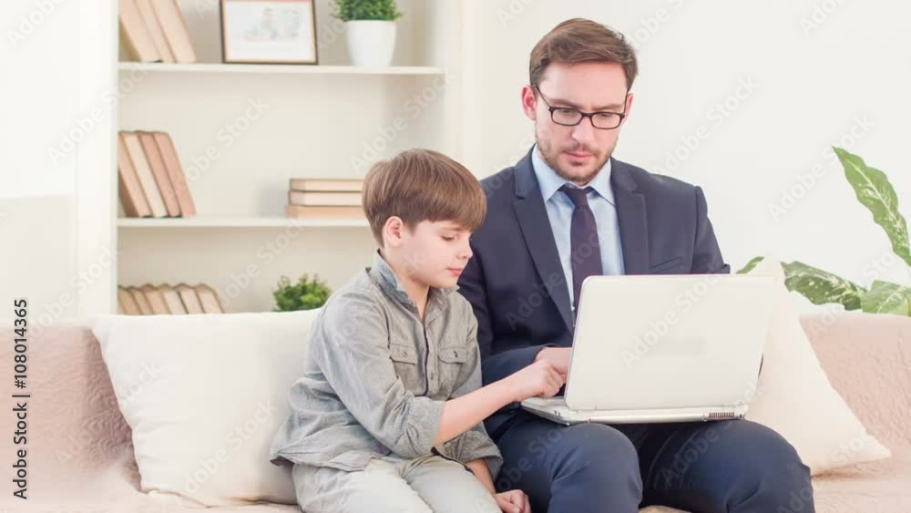 Father and his son sitting on the couch Father and his son sitting on the couch