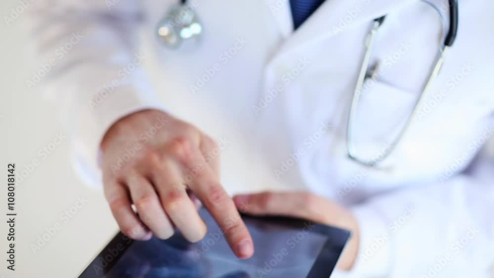doctor working with x-ray scan on tablet pc doctor working with x-ray scan on tablet pc