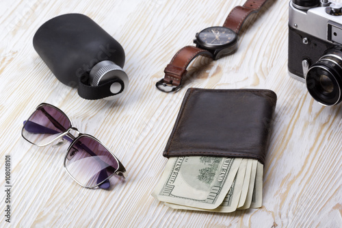 gentlemanly set: sunglasses, perfume, wallet,camera, watch on wooden background