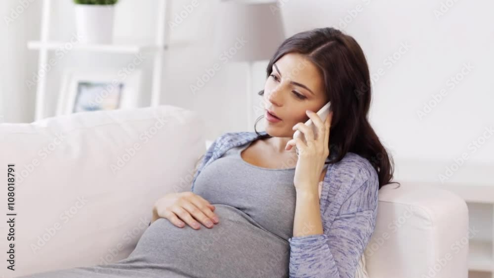 sad pregnant woman calling on smartphone at home sad pregnant woman calling on smartphone at home